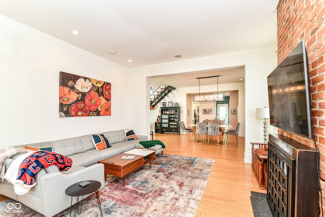 1630 N New Jersey St, Indianapolis, IN 46202 - living room featuring light wood finished floors, stairway, a chandelier, and recessed lighting