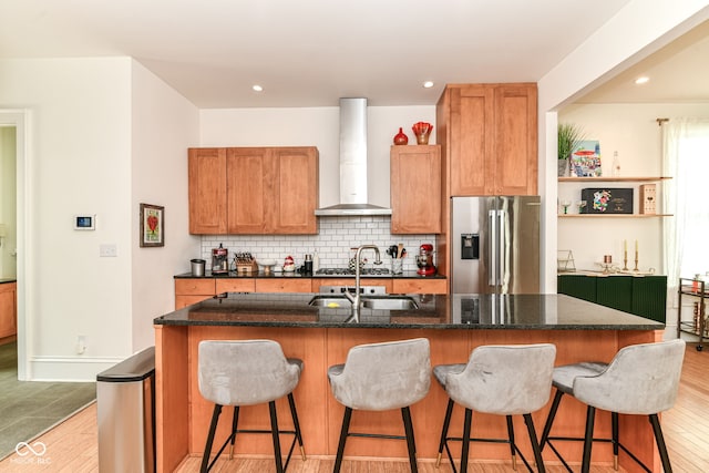 1630 N New Jersey St, Indianapolis, IN 46202 - kitchen featuring high end refrigerator, wall chimney range hood, a sink, light wood-style floors, and decorative backsplash