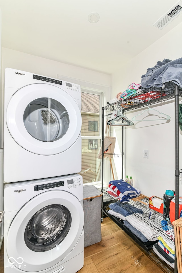 1630 N New Jersey St, Indianapolis, IN 46202 - laundry area with stacked washer / dryer and wood finished floors