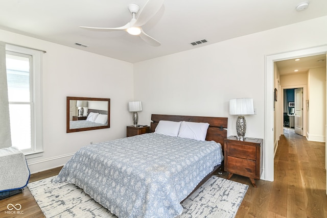 1630 N New Jersey St, Indianapolis, IN 46202 - bedroom with wood finished floors, baseboards, multiple windows, and a ceiling fan