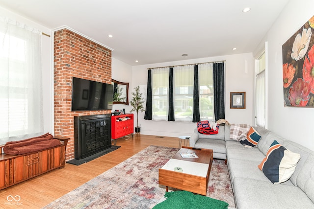 1630 N New Jersey St, Indianapolis, IN 46202 - living room with wood finished floors, healthy amount of natural light, a brick fireplace, and recessed lighting