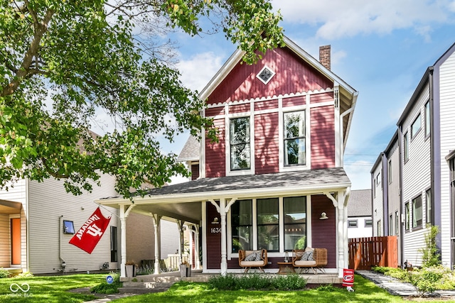 1630 N New Jersey St, Indianapolis, IN 46202 - view of front of house with covered porch and a chimney