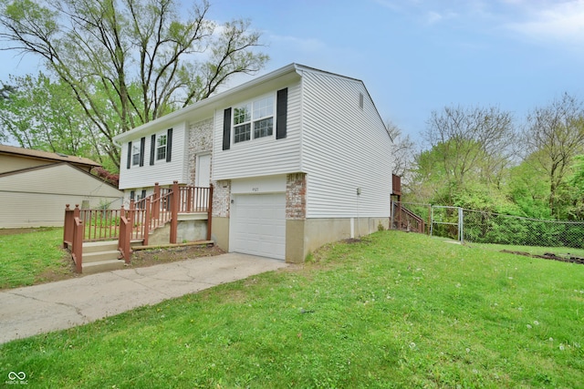raised ranch featuring driveway, a garage, and brick siding