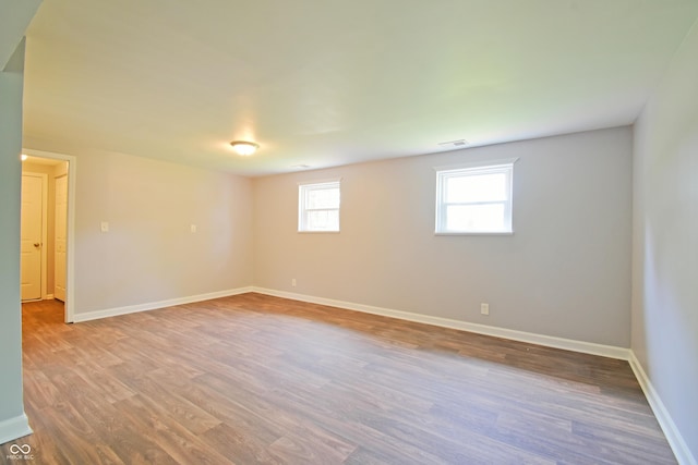 unfurnished room featuring wood finished floors and baseboards