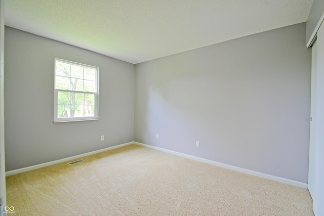 unfurnished room featuring carpet floors and baseboards