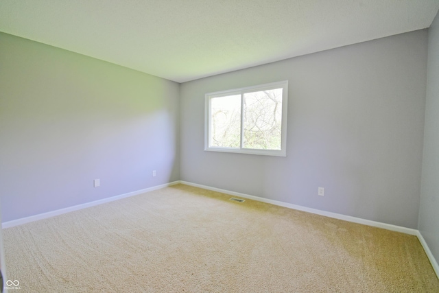 empty room with carpet and baseboards