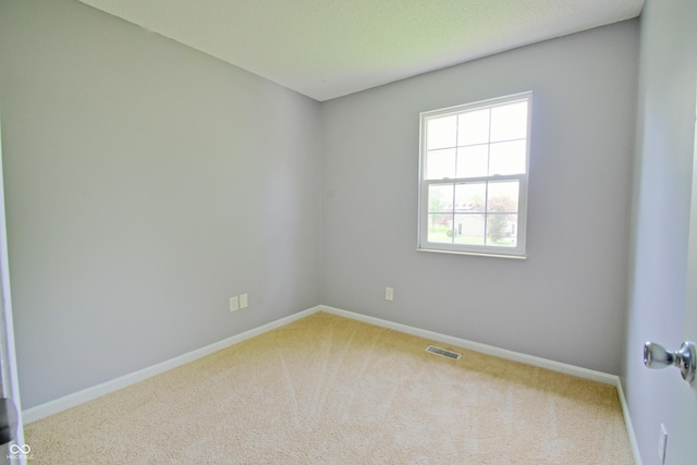 carpeted empty room with baseboards