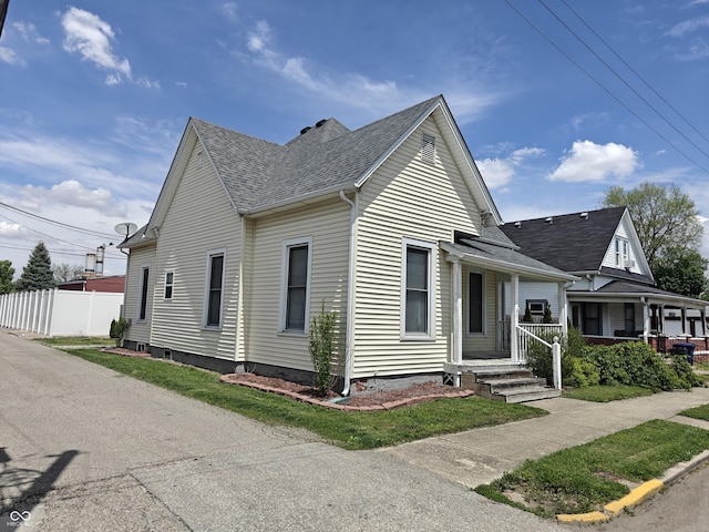 152 1st St W, Shelbyville, IN 46176 - view of front of home featuring a shingled roof, fence, and covered porch