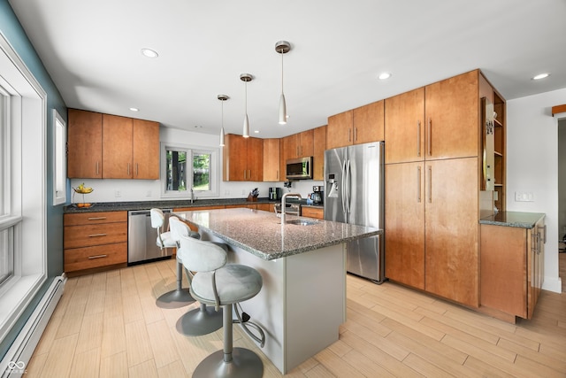 7753 Ivy Dr, Nineveh, IN 46164 - kitchen featuring appliances with stainless steel finishes, a baseboard radiator, brown cabinets, dark stone counters, and recessed lighting