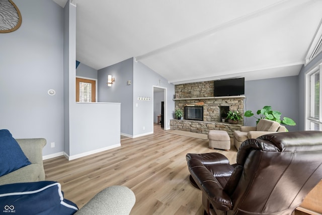 7753 Ivy Dr, Nineveh, IN 46164 - living area with lofted ceiling, wood finished floors, baseboards, and a stone fireplace