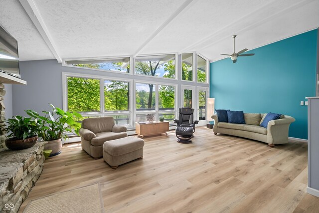 7753 Ivy Dr, Nineveh, IN 46164 - living area with ceiling fan, healthy amount of natural light, lofted ceiling, wood finished floors, and a textured ceiling