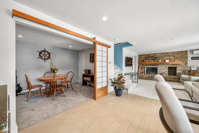 7753 Ivy Dr, Nineveh, IN 46164 - carpeted dining space featuring a barn door, wood finished floors, a baseboard radiator, stairs, and recessed lighting