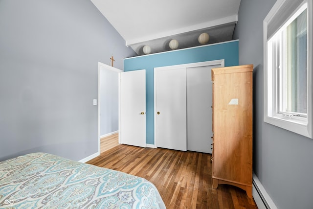 7753 Ivy Dr, Nineveh, IN 46164 - bedroom with hardwood / wood-style floors, baseboard heating, vaulted ceiling, a closet, and baseboards