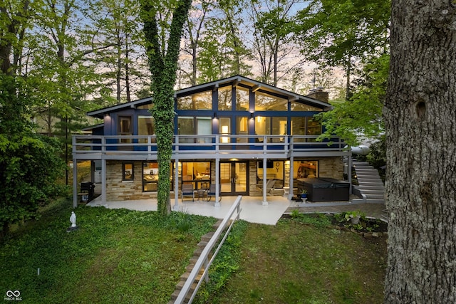 7753 Ivy Dr, Nineveh, IN 46164 - back of property with a hot tub, stone siding, a patio area, and french doors