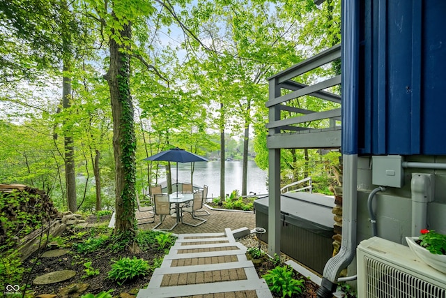 7753 Ivy Dr, Nineveh, IN 46164 - view of yard featuring a water view, a hot tub, a cooling unit, a patio, and outdoor dining area