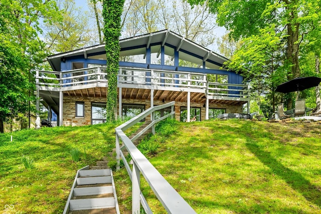 7753 Ivy Dr, Nineveh, IN 46164 - rear view of house featuring stone siding, a deck, and a yard