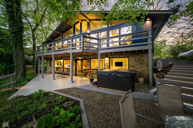 7753 Ivy Dr, Nineveh, IN 46164 - back of property featuring a hot tub, stone siding, a patio, and a wooden deck