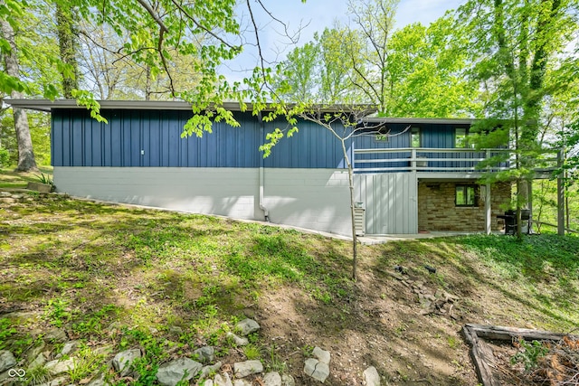 7753 Ivy Dr, Nineveh, IN 46164 - view of property exterior featuring board and batten siding, a wooden deck, and stone siding