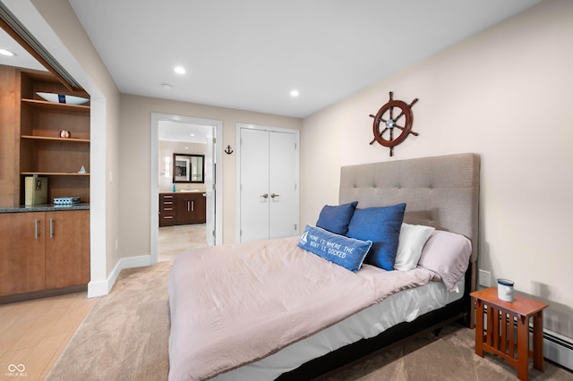 7753 Ivy Dr, Nineveh, IN 46164 - bedroom with recessed lighting, connected bathroom, a baseboard radiator, light wood-style flooring, and a closet