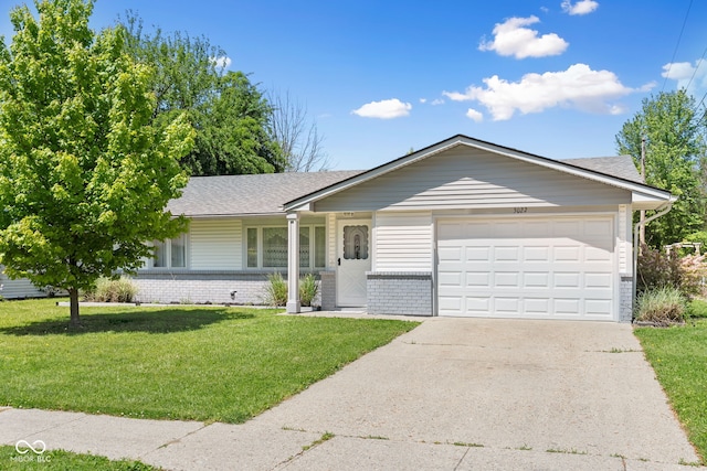 ranch-style house featuring brick siding, a garage, a front yard, and concrete driveway