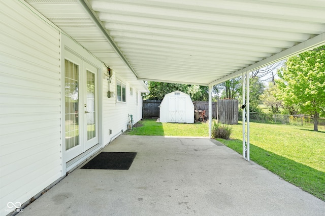 view of patio / terrace featuring a shed, french doors, an outbuilding, and an attached carport