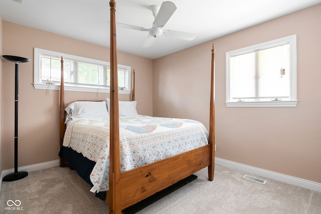 carpeted bedroom with baseboards and ceiling fan