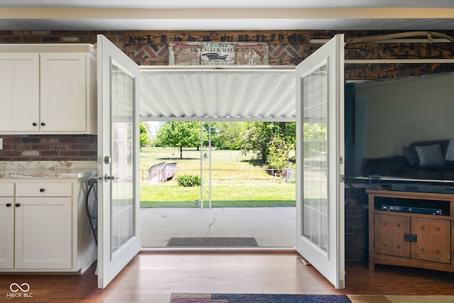 doorway to outside featuring french doors and wood finished floors