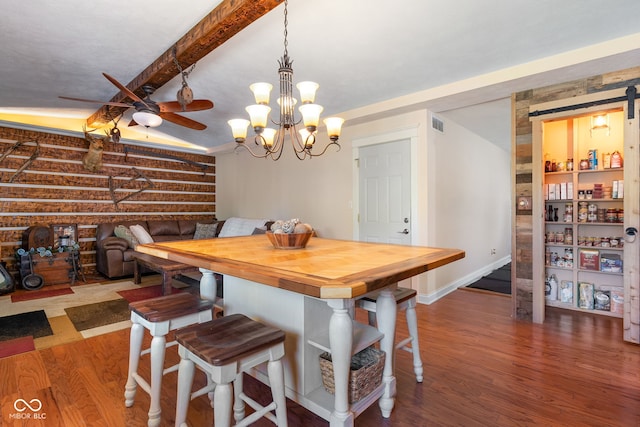 dining room with wood finished floors, a ceiling fan, baseboards, and a chandelier
