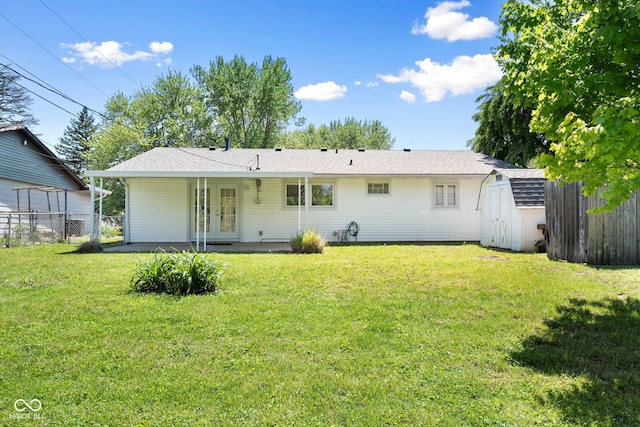 back of property featuring a storage shed, french doors, an outdoor structure, and a patio