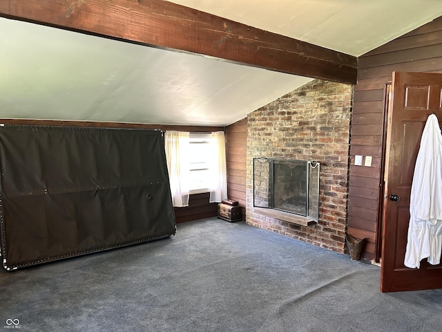 3081 Woodridge Rd, Shelbyville, IN 46176 - unfurnished living room with lofted ceiling, wood walls, carpet floors, and a brick fireplace