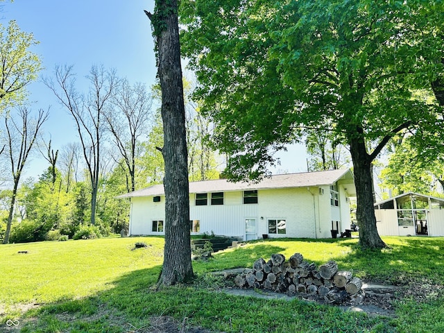 3081 Woodridge Rd, Shelbyville, IN 46176 - back of house with a lawn and brick siding