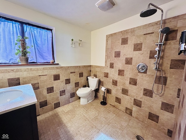 3081 Woodridge Rd, Shelbyville, IN 46176 - full bathroom with tile walls, vanity, a tile shower, toilet, and wainscoting