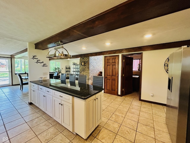 3081 Woodridge Rd, Shelbyville, IN 46176 - kitchen with dark countertops, light tile patterned flooring, white cabinetry, beam ceiling, and baseboards