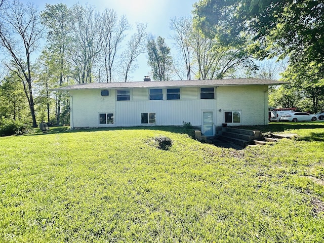3081 Woodridge Rd, Shelbyville, IN 46176 - rear view of property featuring a lawn, brick siding, and a chimney