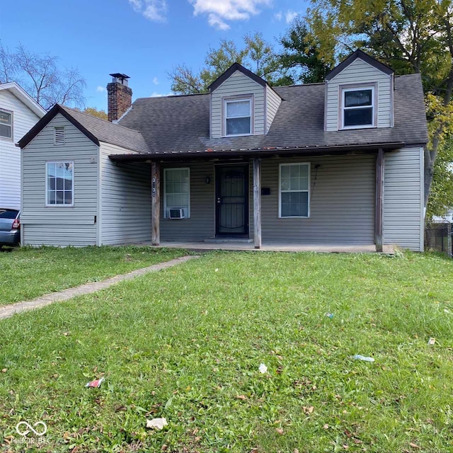 3731 N Tacoma Ave, Indianapolis, IN 46218 - view of front facade with a front lawn, covered porch, a shingled roof, cooling unit, and a chimney