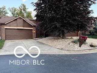 209 Brighton Ct, Greenwood, IN 46143 - view of property hidden behind natural elements with concrete driveway and a garage