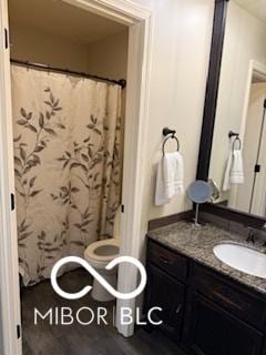 209 Brighton Ct, Greenwood, IN 46143 - bathroom with vanity, a shower with curtain, toilet, and wood finished floors