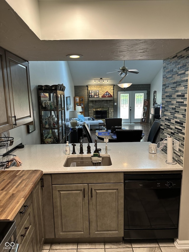 209 Brighton Ct, Greenwood, IN 46143 - kitchen featuring dishwasher, a ceiling fan, a stone fireplace, a sink, and wood counters