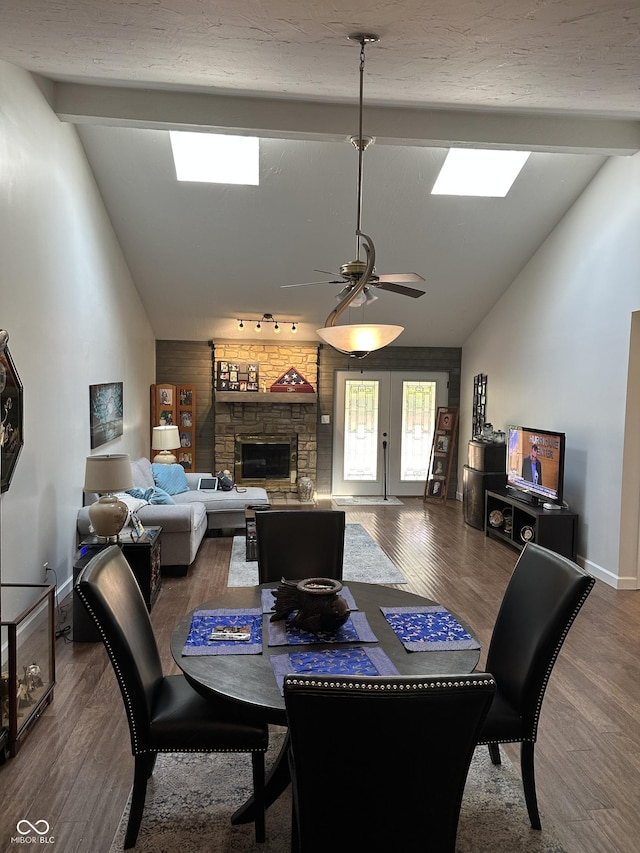 209 Brighton Ct, Greenwood, IN 46143 - dining area with wood finished floors, a ceiling fan, french doors, and a fireplace