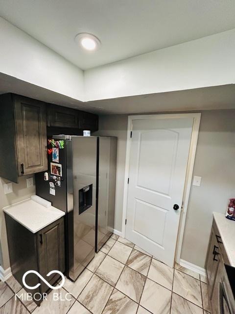 209 Brighton Ct, Greenwood, IN 46143 - kitchen featuring light countertops, stainless steel fridge with ice dispenser, and baseboards