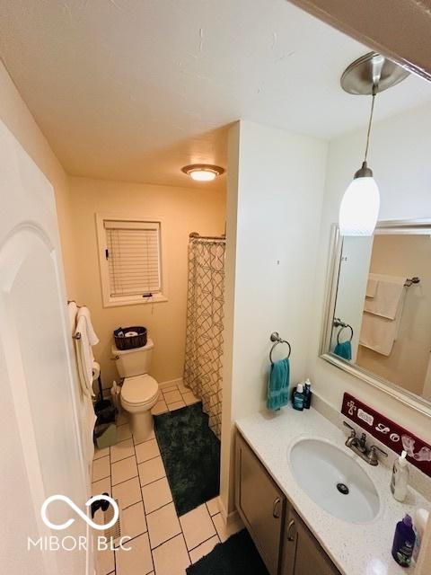 209 Brighton Ct, Greenwood, IN 46143 - full bath with tile patterned floors, vanity, toilet, and curtained shower