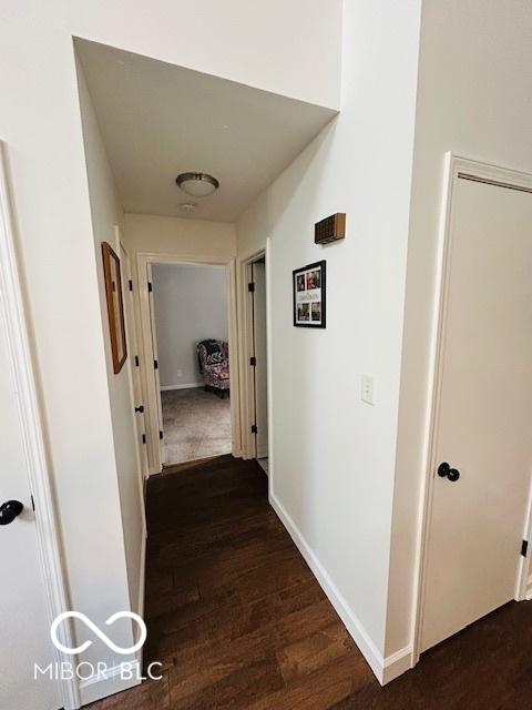 209 Brighton Ct, Greenwood, IN 46143 - hallway featuring dark wood finished floors and baseboards