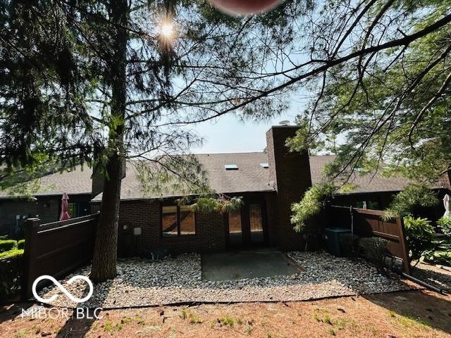 209 Brighton Ct, Greenwood, IN 46143 - back of property featuring a patio and brick siding