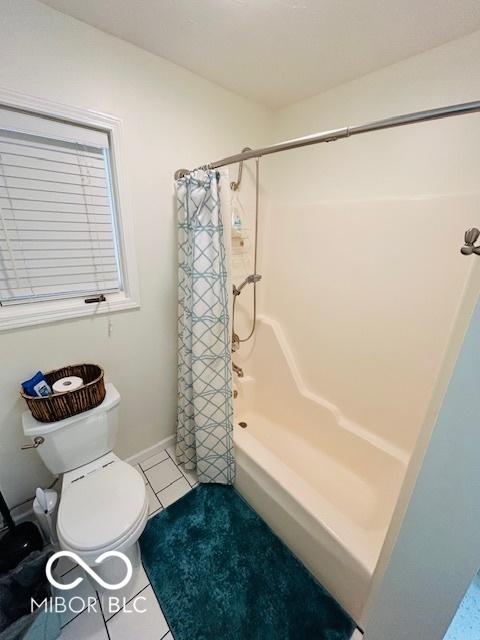 209 Brighton Ct, Greenwood, IN 46143 - bathroom featuring tile patterned flooring, toilet, shower / tub combo, and baseboards