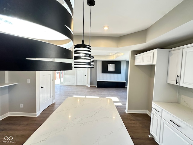 337 N Beville Ave, Indianapolis, IN 46201 - kitchen featuring baseboards, white cabinetry, light stone countertops, and decorative light fixtures