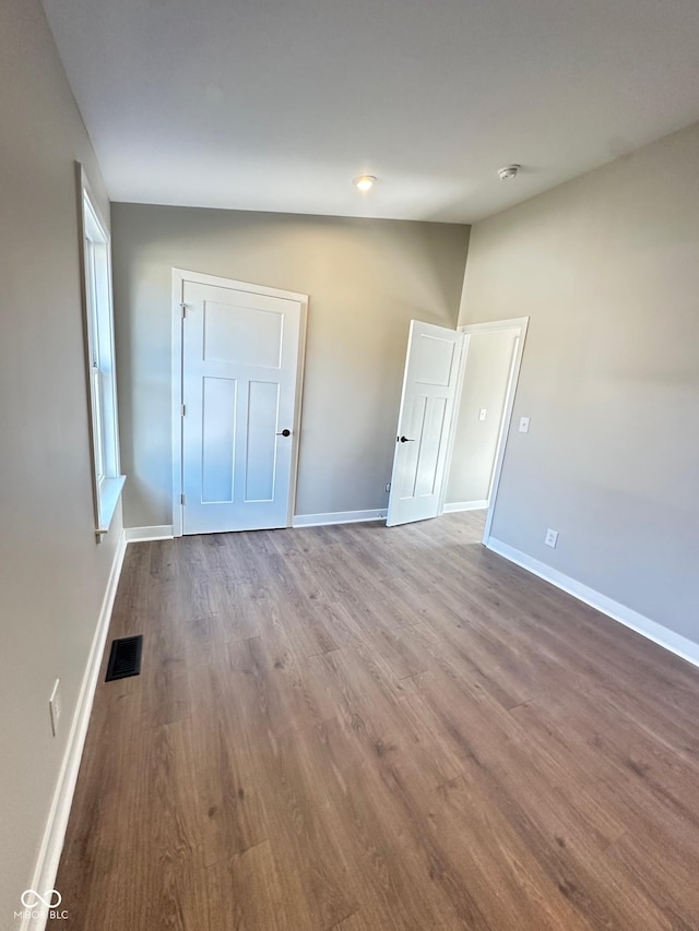 337 N Beville Ave, Indianapolis, IN 46201 - unfurnished bedroom featuring wood finished floors and baseboards