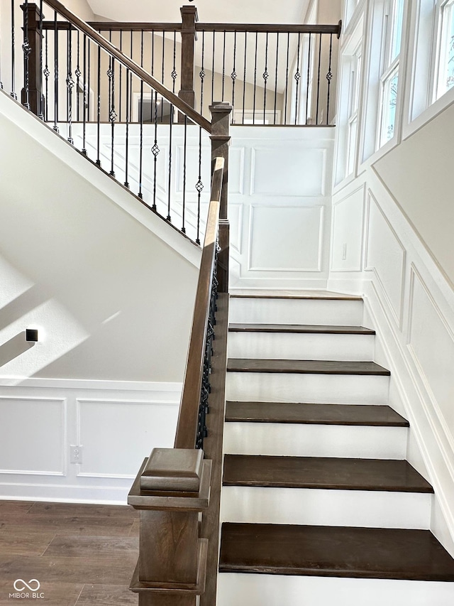 337 N Beville Ave, Indianapolis, IN 46201 - stairs featuring a decorative wall, wood finished floors, and wainscoting