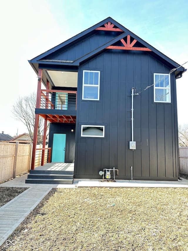 337 N Beville Ave, Indianapolis, IN 46201 - view of front of property featuring board and batten siding, a balcony, and fence