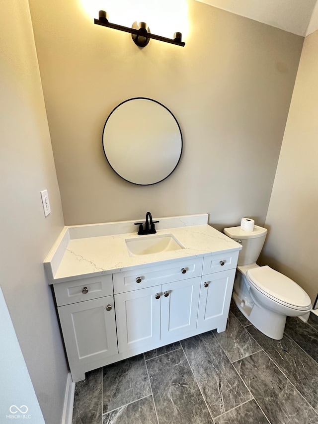 337 N Beville Ave, Indianapolis, IN 46201 - half bathroom featuring vanity, toilet, and baseboards