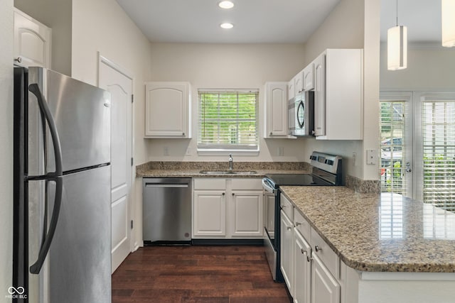 kitchen featuring appliances with stainless steel finishes, a sink, dark wood-style flooring, recessed lighting, and white cabinetry